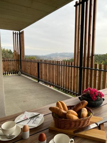 a basket of bread on a table on a balcony at Haus Nebel in Oberhaag