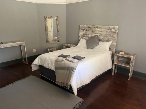 a bedroom with a large bed with two towels on it at Cosy and Serene Environment in Boksburg