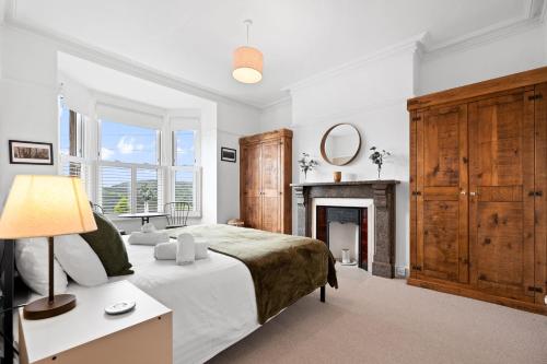 a bedroom with a bed and a fireplace at Wellington - Matlock in Matlock