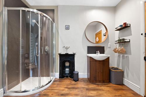 a bathroom with a shower and a sink and a mirror at Wellington - Matlock in Matlock