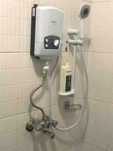 a soap dispenser on a wall in a bathroom at KareBer Deluxe - Gulu - Uganda in Gulu