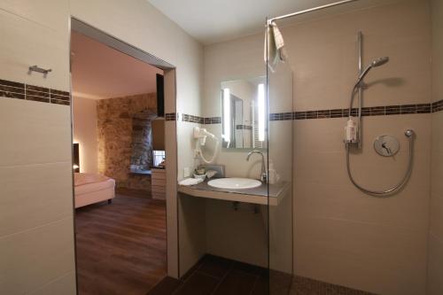 a bathroom with a sink and a shower at Schlosshotel Weilburg in Weilburg