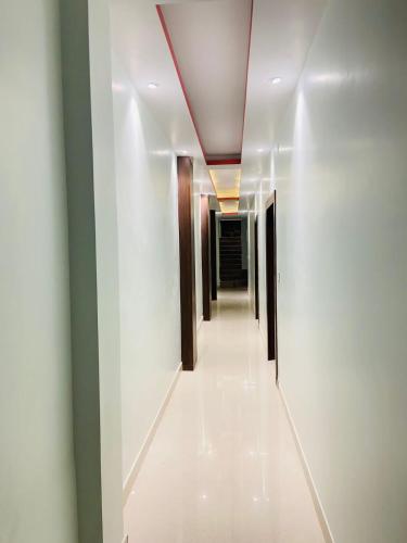 a corridor of a hallway with a ceiling at Hotel Grill inn in Lucknow