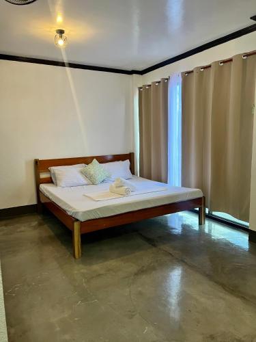a bedroom with a bed in a room at Hidden Gem Siargao in General Luna