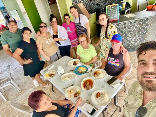 a group of people sitting around a table eating food at Emerald Apartments INC in Georgetown