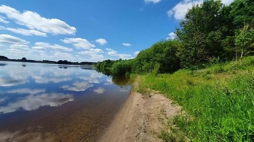 a body of water with trees and clouds in the sky at Three-Bedroom Home in Tulfarris Village, Wicklow in Blessington