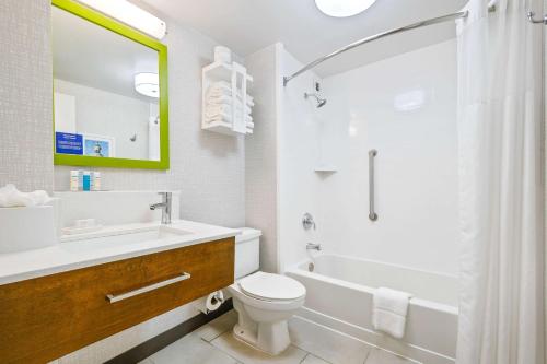 a bathroom with a sink and a toilet and a shower at Hampton Inn St. Louis - Westport in Maryland Heights