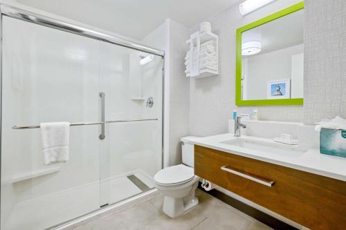 a bathroom with a shower and a toilet and a sink at Hampton Inn St. Louis - Westport in Maryland Heights