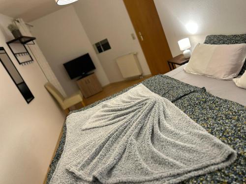a bedroom with a bed with a blanket on it at Melody's Apartment in Nordenham