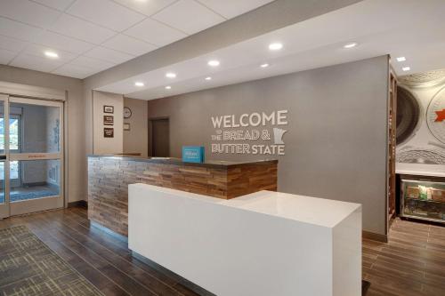 a lobby with a welcome sign and a counter at Hampton Inn Lakeville Minneapolis, Mn in Lakeville