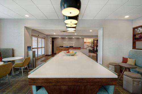 a lobby of a waiting room with a table and chairs at Hampton Inn Lakeville Minneapolis, Mn in Lakeville