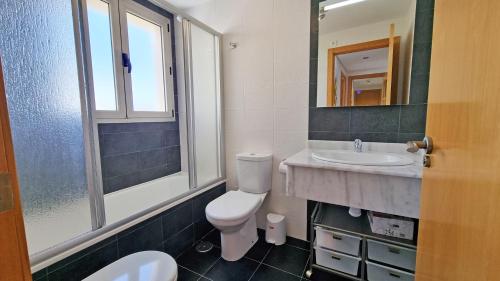 a bathroom with a toilet and a sink at Torre Lugano - Gran terraza con vistas in Benidorm