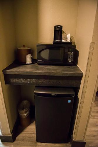 a microwave sitting on a counter next to a trash can at Distill-Inn in Bardstown