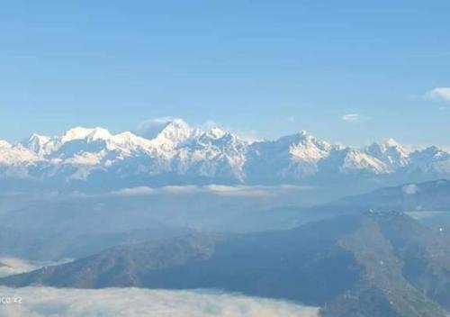 a view of a mountain range with a body of water at Bomzan Homestay by StayApart in Takdāh