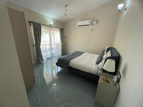 a small bedroom with a bed and a window at Joets Guesthouse in Bogmolo