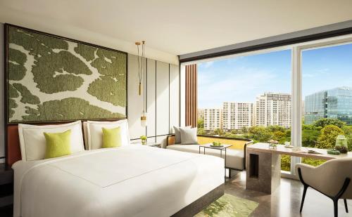 a bedroom with a bed and a large window at Taj The Trees, Mumbai in Mumbai