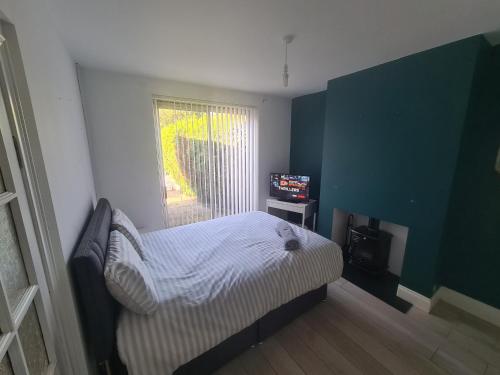 a small bedroom with a bed and a television at L & J Escapes - 8 Bedrooms suitable for Contractors and Families- Private parking available for 6 vehicles in Coseley