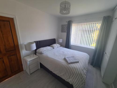 a small bedroom with a bed and a window at L & J Escapes - 8 Bedrooms suitable for Contractors and Families- Private parking available for 6 vehicles in Coseley