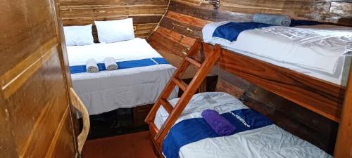 a room with two bunk beds and a small bed at familykomodocruise in Labuan Bajo
