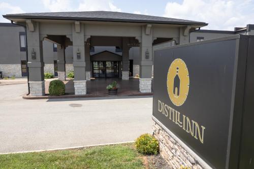 a building with a sign in front of a building at Distill-Inn in Bardstown