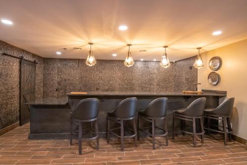 a bar in a restaurant with black stools at Distill-Inn in Bardstown