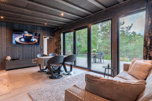 a living room with a table and chairs at Dream Corner Nordic in Laulasmaa