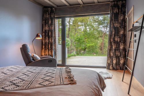 a bedroom with a bed and a large window at Dream Corner Nordic in Laulasmaa