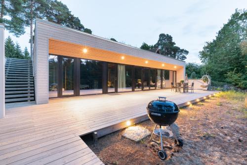 a house with a grill on a wooden deck at Dream Corner Nordic in Laulasmaa