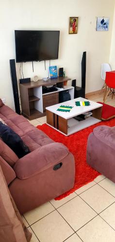 a living room with a couch and a table at 2 Bedroom Apartment in Langata in Nairobi