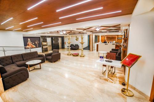a living room with a couch and a table at KKM INTERNATIONAL in Trivandrum