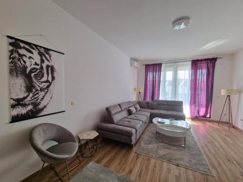a living room with a couch and a table at Flat Rafailovic One minute to Beach in Budva