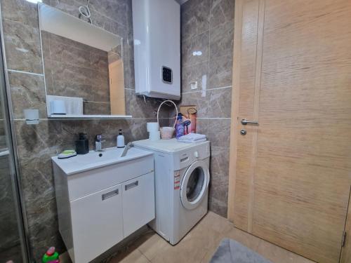 a bathroom with a washing machine and a washer at Flat Rafailovic One minute to Beach in Budva