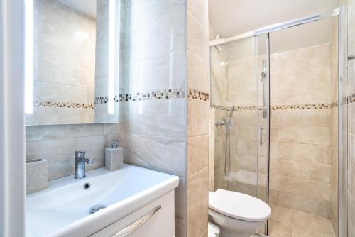 a bathroom with a toilet sink and a shower at Apartments Vila Toni in Portorož