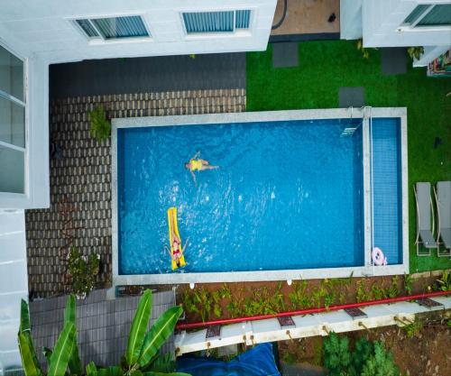 a large swimming pool on the side of a building at HUE GUH The Porto Candolim in Calangute
