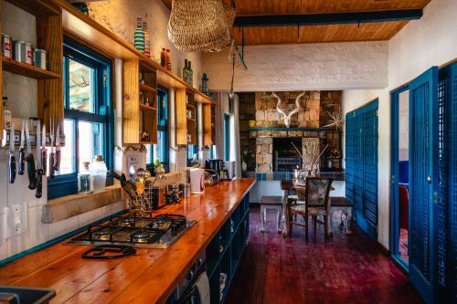 a kitchen with a wooden counter top in a room at Anglers Court in Dullstroom
