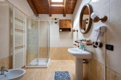 a bathroom with a shower and a sink and a mirror at Jolly Private Room With Bathroom in Marghera
