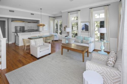 a living room with white furniture and a kitchen at Beautiful 2 BR WaterColor 6 WaterColor Blvd #201 Steps to Beach Club condo in Santa Rosa Beach