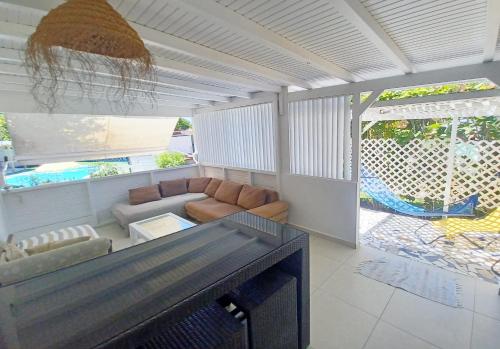 a living room with a couch and a table at La Rose du Bresil Marie-Galante in Capesterre-de-Marie-Galante