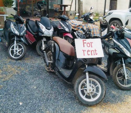 a group of motorcycles parked next to each other with a sign on it at Baan phuwamin in Ko Lanta