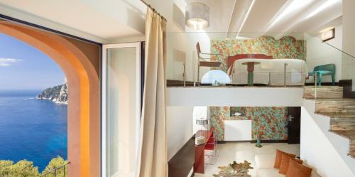 a bedroom with a view of the ocean at Hotel Punta Tragara in Capri