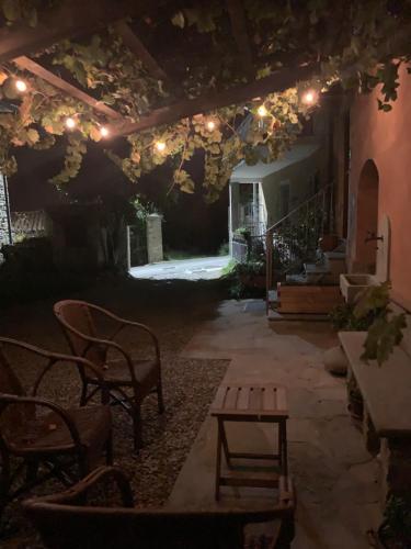 a patio with a table and chairs and lights at Ca d’Censo in Marsaglia