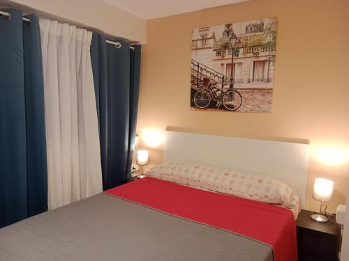 a bedroom with a bed with a red blanket at Private Room Service - Grupo RH Santander in Santander