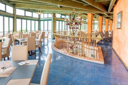 a dining room with tables and chairs in a building at Centro Vacanze La Limonaia in Limone sul Garda