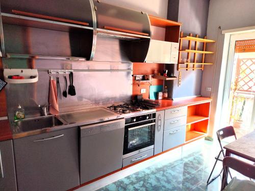 a kitchen with a stove and a sink at Euforbia House in Lido di Ostia