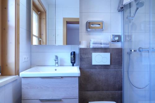 a bathroom with a sink and a shower at Hotel Malteinerhof in Malta