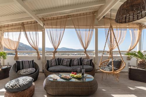 a living room with a couch and chairs and a table at Black Velvet in Agkidia