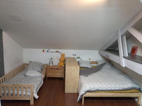 Cette chambre comprend deux lits, un bureau et des lits superposés. dans l'établissement Maison cosy au calme Bordeaux, à Mérignac