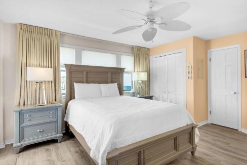 a bedroom with a large bed and a ceiling fan at St Thomas Square Villa 1211C Beach Bumz in Panama City Beach