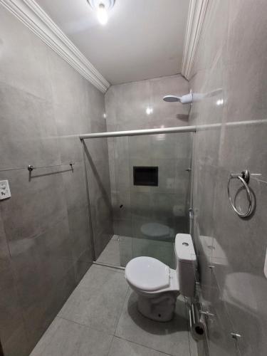 a bathroom with a toilet and a shower at Pousada Primeiro Sol in João Pessoa