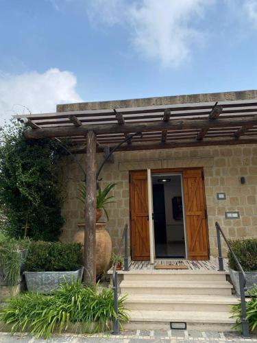 a wooden entrance to a house with a wooden door at Il Barbacane in Bacoli